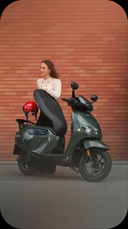 Two women sharing a moment beside a red scooter
