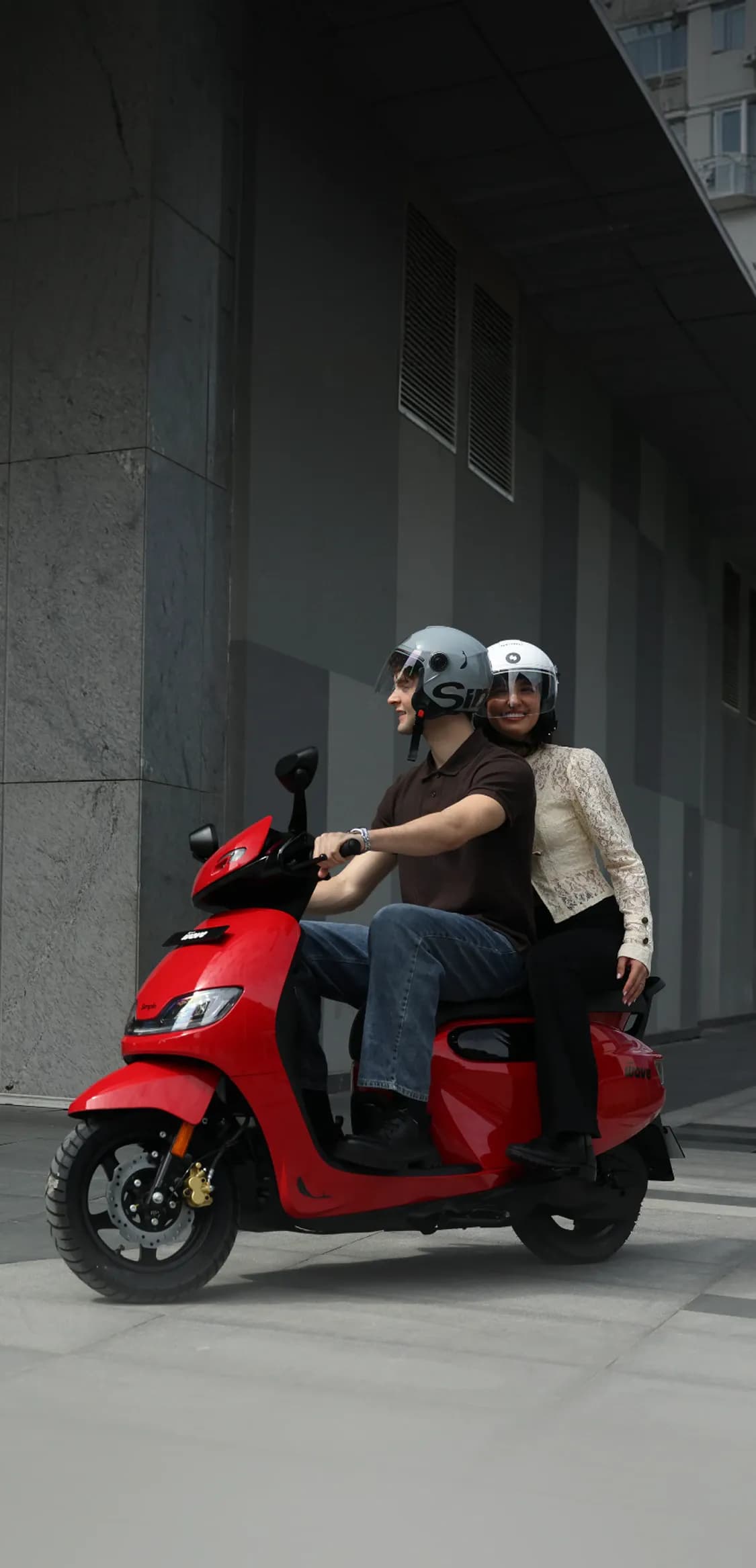 A family enjoying a ride on a blue scooter